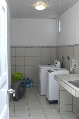 a small bathroom with a washing machine and a sink at Apto D Laidman y Raabe SRL in Mercedes