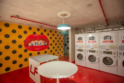 a laundry room with a mouth on the wall at Jungle at 24, City Views and Wonderland Vibes! in Hatillo