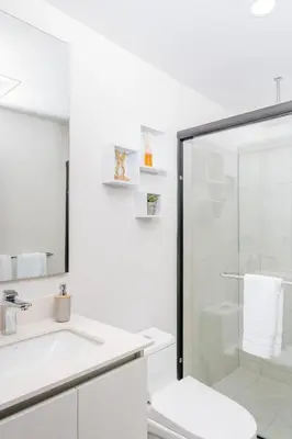 a white bathroom with a shower and a toilet at Jungle at 24, City Views and Wonderland Vibes! in Hatillo