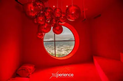a red room with a round window and a chandelier at Firefly at 29, City Views and Wonderland Vibes! in Hatillo