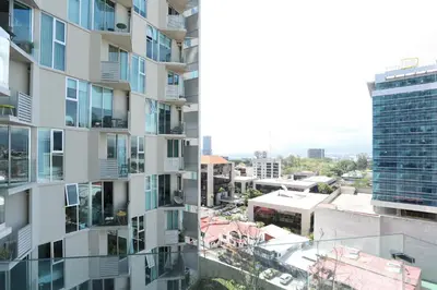 an aerial view of a tall apartment building at Sunflower at 12, City Views and Wonderland Vibes! in Hatillo
