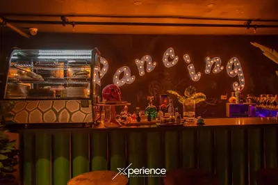 a bar with a sign on the wall of a restaurant at Teal at 12, City Views and Wonderland Vibes! in Hatillo