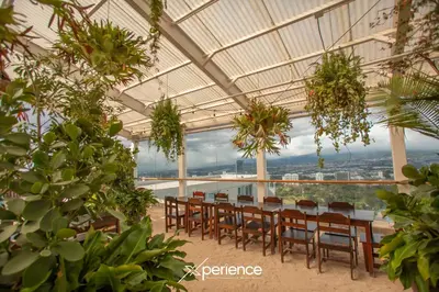 a dining room with a table and chairs in a building at Indigo at 11, City Views and Wonderland Vibes! in Hatillo