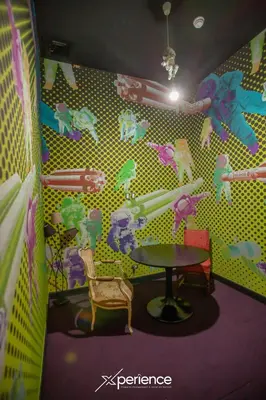 a room with a table and a dinosaur wall at Indigo at 11, City Views and Wonderland Vibes! in Hatillo