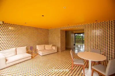 a living room with a table and a couch and chairs at Serenitas at 20, City Views and Wonderland Vibes! in Hatillo