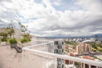 a balcony with a view of a city at Serenity at 12, City Views and Wonderland Vibes! in Hatillo