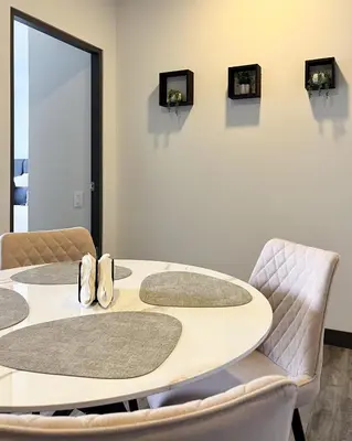 a table with two chairs and a table with mirrors at Serenity at 12, City Views and Wonderland Vibes! in Hatillo