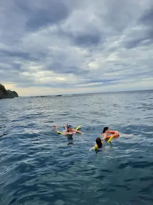 a group of people swimming in the water at Casa Mor - Surfhouse - 2 min from the beach in Santa Teresa Beach