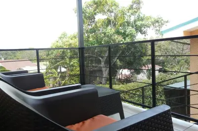 a balcony with chairs and a view of trees at Apto D Laidman y Raabe SRL in Mercedes