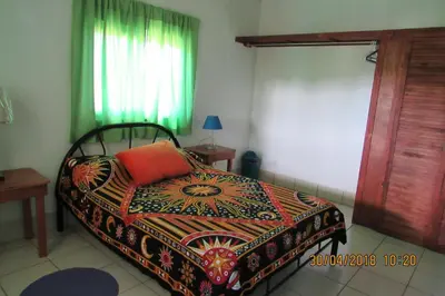 a bedroom with a bed with a colorful blanket and a window at Apto D Laidman y Raabe SRL in Mercedes