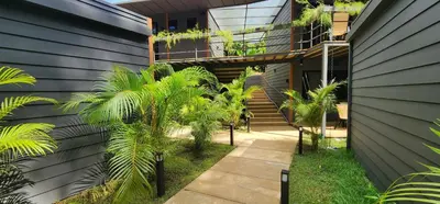 a house with palm trees on the side of it at Hotel Evasión in Ojochal
