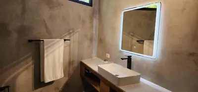 a bathroom with a sink and a mirror at Hotel Evasión in Ojochal