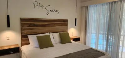a bedroom with a bed with a sign on the wall at Hotel Evasión in Ojochal