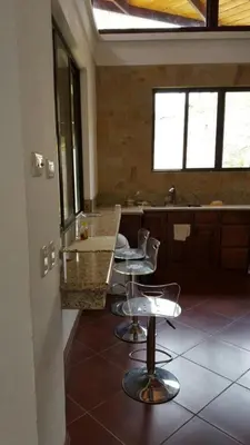 a kitchen with two chairs and a counter in a room at Casita en la finca Los Bambú in Jaris