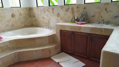 a large bathroom with a tub and a sink at Casita en la finca Los Bambú in Jaris