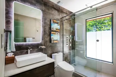 a bathroom with a sink and a toilet and a mirror at Beachfront Villa, Private Pool & Daily Breakfast in Potrero