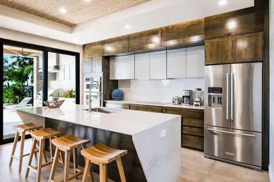 a kitchen with a large island with bar stools at Beachfront Villa, Private Pool & Daily Breakfast in Potrero