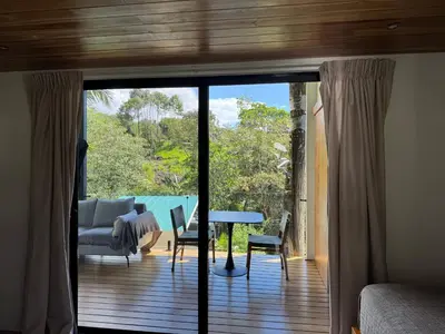 a room with a sliding glass door with a table and chairs at Casa Rucca in Uvita