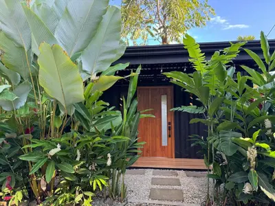 a house with a bunch of plants in front of it at Casa Rucca in Uvita