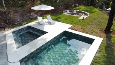 an overhead view of a swimming pool with an umbrella at Pandanus Lodge & Retreats Bungalow Strelizia in San Ramón