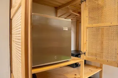 a metal door in a closet with wooden cabinets at Pandanus Lodge & Retreats Bungalow Strelizia in San Ramón