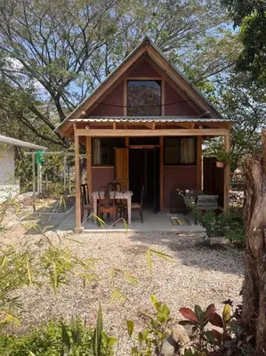 a small house with a porch and a table at Nosara Hemp House in Nosara