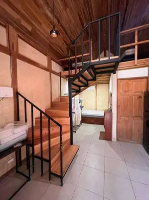 a room with a spiral staircase in a house at Nosara Hemp House in Nosara