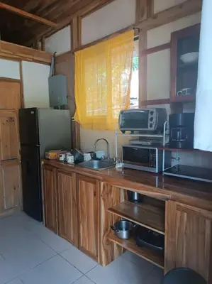 a kitchen with a sink and a refrigerator at Nosara Hemp House in Nosara