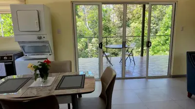 a kitchen with a table and chairs and a large window at Villas Pura Vida - Guapinol in Río Negro