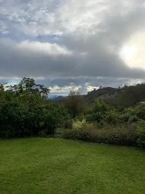 a green field with a view of the mountains at Refugio Monteverde house, privacy & ocean view! in Monteverde Costa Rica