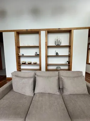 a living room with a couch and shelves at Refugio Monteverde house, privacy & ocean view! in Monteverde Costa Rica