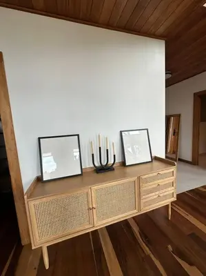a wooden cabinet with two pictures on top of it at Refugio Monteverde house, privacy & ocean view! in Monteverde Costa Rica