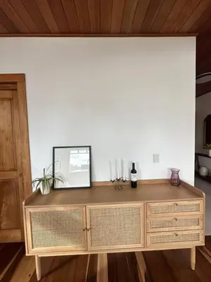 a wooden dresser in a room with a white wall at Refugio Monteverde house, privacy & ocean view! in Monteverde Costa Rica