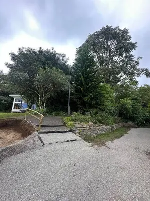 a road with trees and a street sign on it at Refugio Monteverde house, privacy & ocean view! in Monteverde Costa Rica
