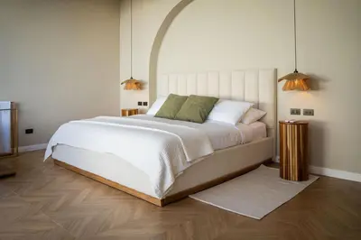 a bedroom with a large white bed and two lamps at Luxury villa on the Cloud Forest Infinity Pool in Monteverde Costa Rica