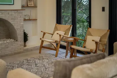 a living room with chairs and a fireplace at Luxury villa on the Cloud Forest Infinity Pool in Monteverde Costa Rica