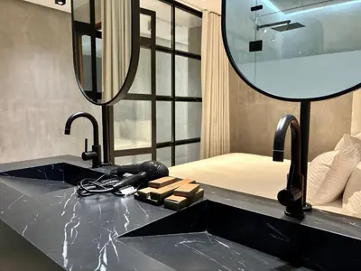 a bathroom with a sink and a mirror at Blooma Boutique Hotel in Santa Teresa Beach