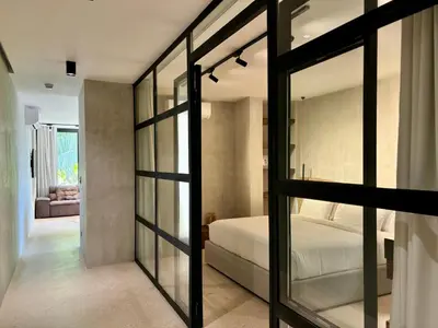 a bedroom with a bed and sliding glass doors at Blooma Boutique Hotel in Santa Teresa Beach