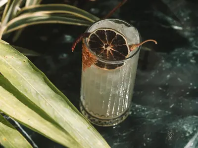 a glass of water with a plant in it at Blooma Boutique Hotel in Santa Teresa Beach