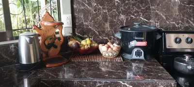 a counter top with a coffee maker and a basket of eggs at La dulce Casita in Uvita