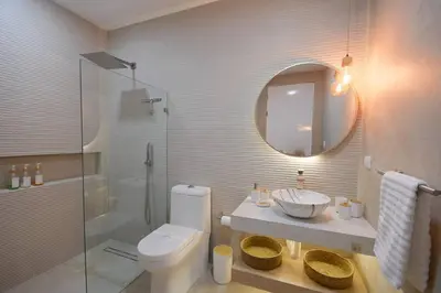 a bathroom with a toilet and a sink and a mirror at Villa Calula in Playa Hermosa