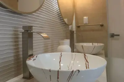 a bathroom with a bowl sink and a mirror at Villa Calula in Playa Hermosa