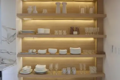 a shelf filled with glasses and plates and dishes at Villa Calula in Playa Hermosa