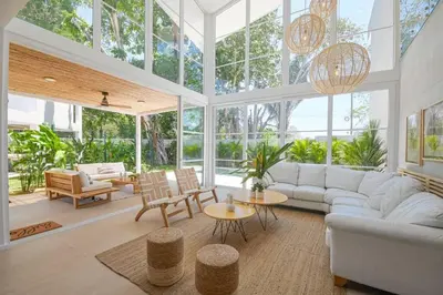 a living room with a lot of windows at Villa Calula in Playa Hermosa