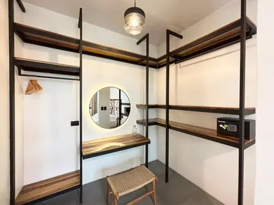 a dressing room with a mirror and a stool at Desiree Luxury Apartamentos in Santa Teresa Beach
