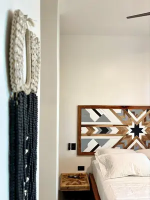 a bedroom with a bed and a mirror at Desiree Luxury Apartamentos in Santa Teresa Beach