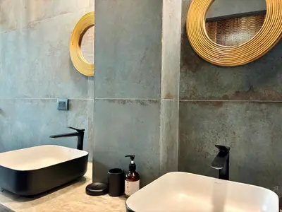 a bathroom with a sink and a bath tub at Desiree Luxury Apartamentos in Santa Teresa Beach