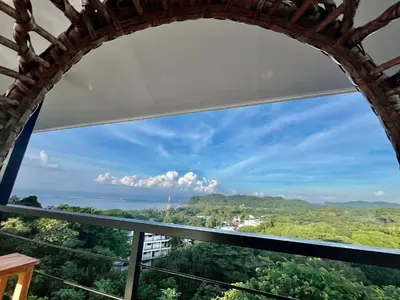 a window in a building with a view of the ocean at Cima Del Mar in Sámara