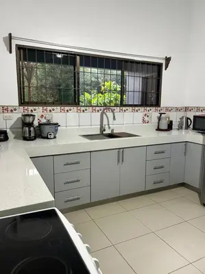 a kitchen with a sink and a window at Hospedaje Santiago in Sarapiquí
