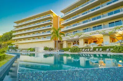 a swimming pool in front of a hotel at Wyndham Tamarindo in Tamarindo